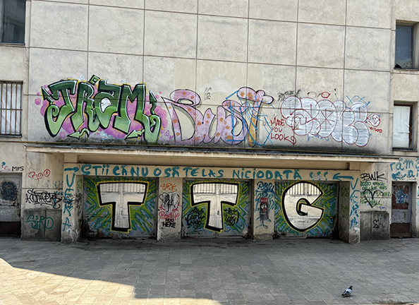 Cinema Republica, now called Trianon, in Iași, Romania, covered in graffiti that says "You know that I will never leave you"